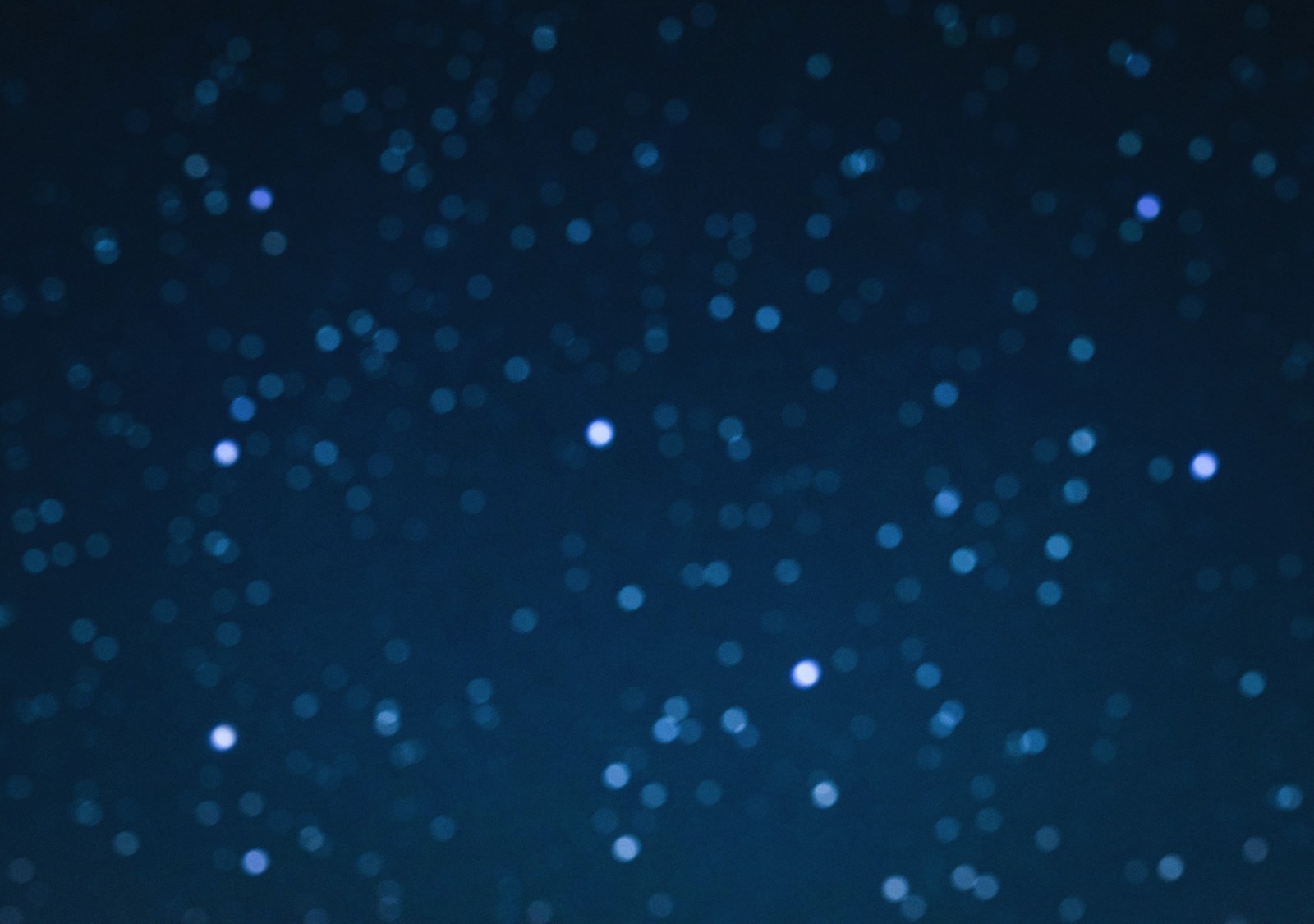 a blurry photo of a night sky with stars