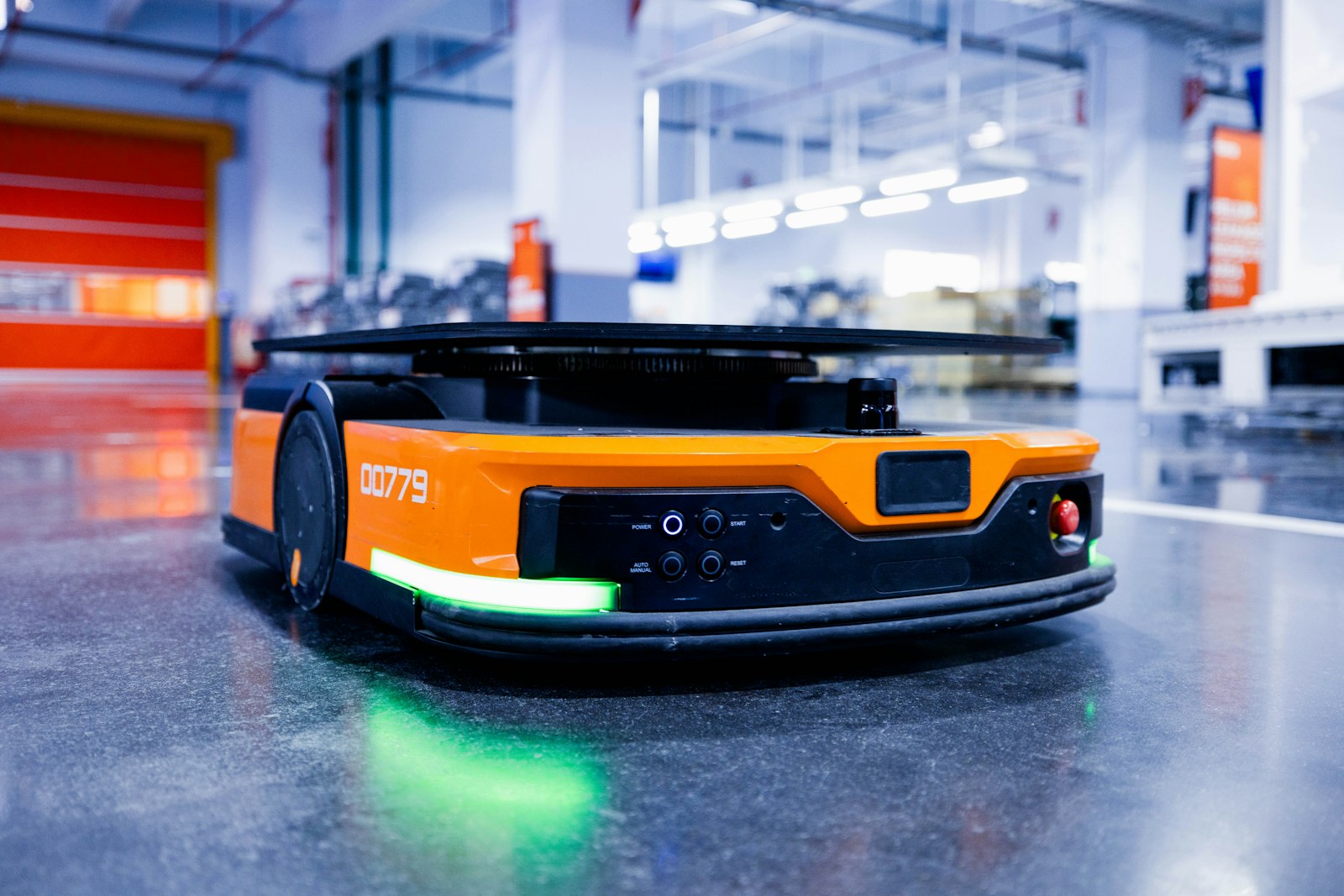 an orange and black vehicle in a garage