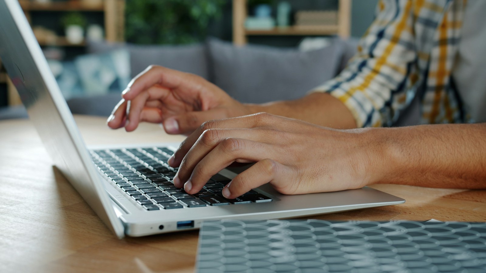 Person typing on a laptop computer at a desk