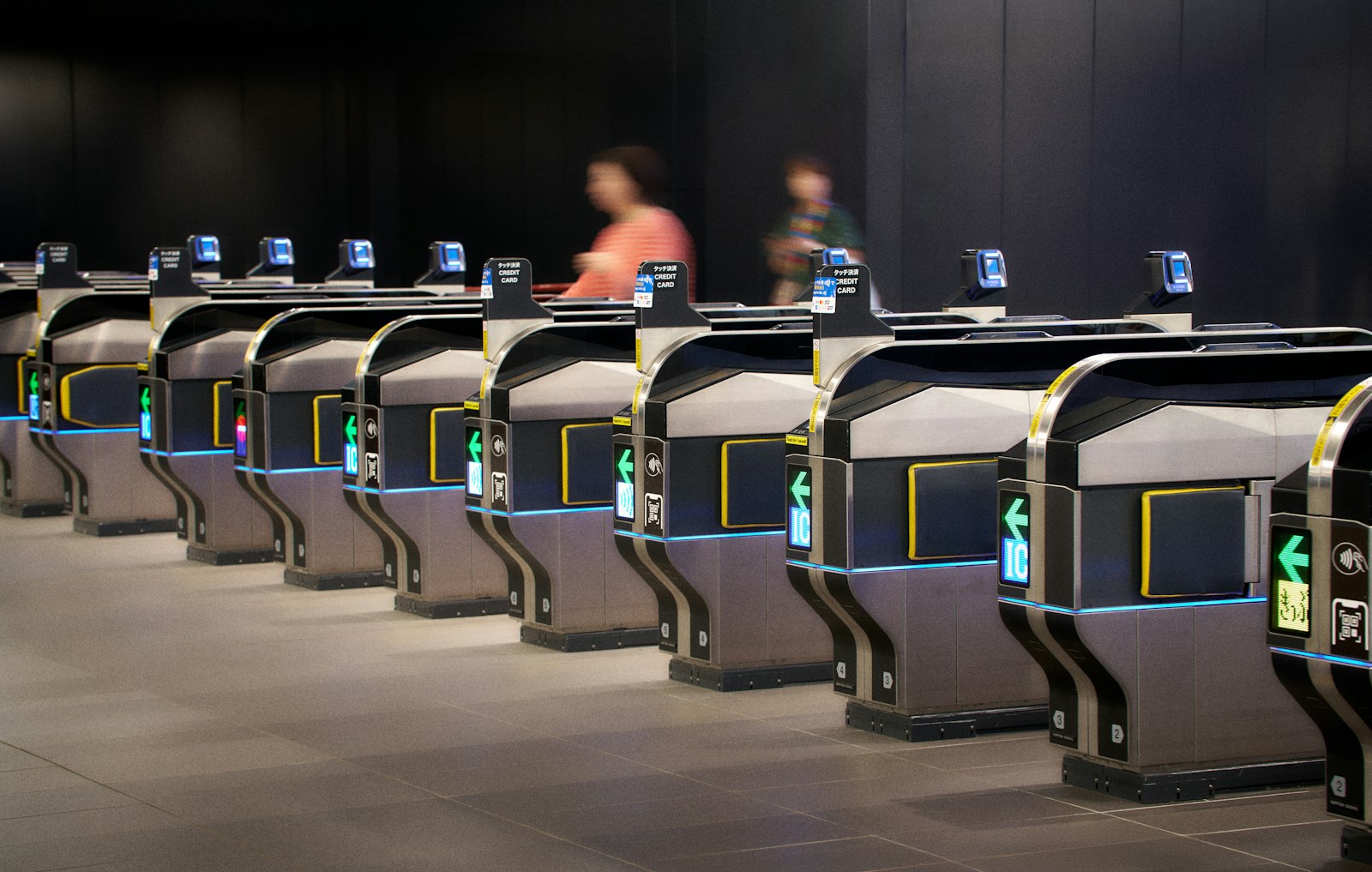 People passing through modern ticket gates in a station