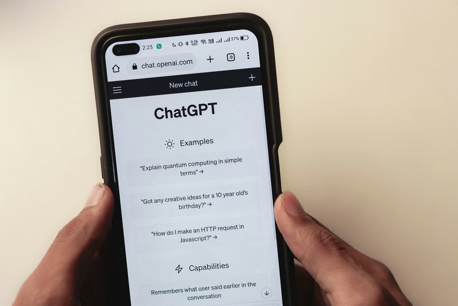 a person holding a cell phone with a chat app on the screen