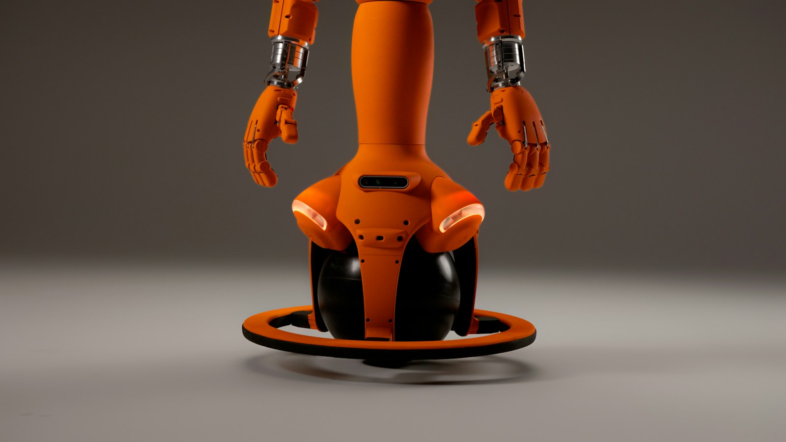An orange robot with wheels and hands