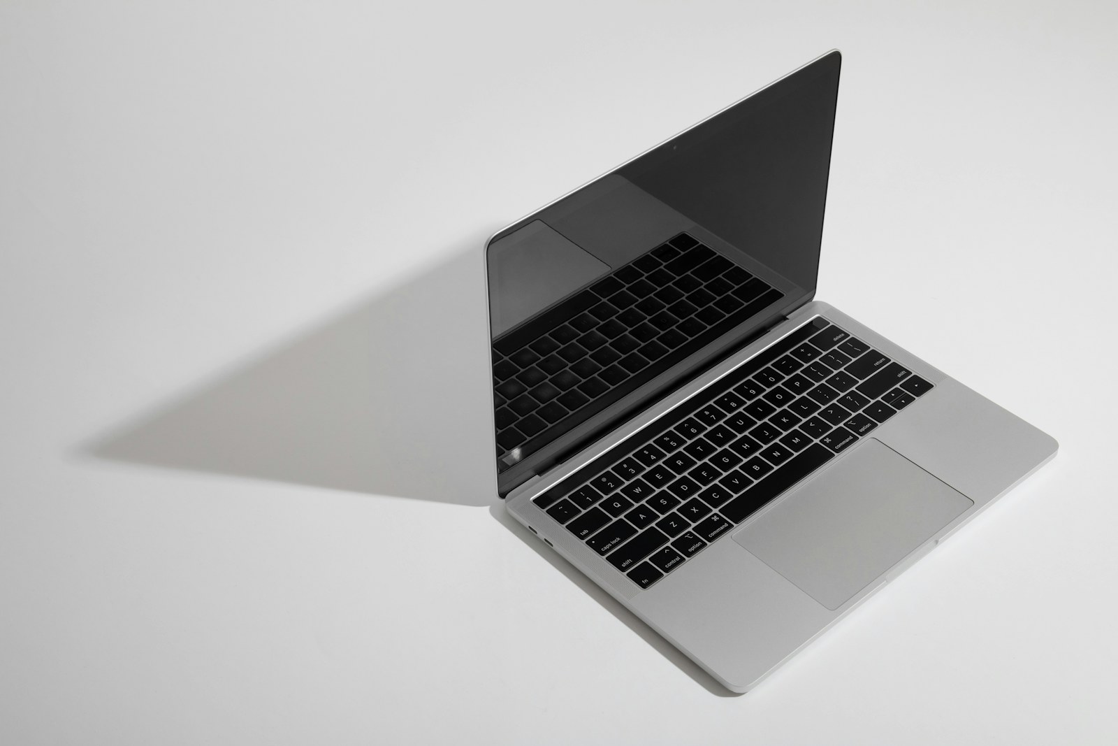 macbook pro on white table