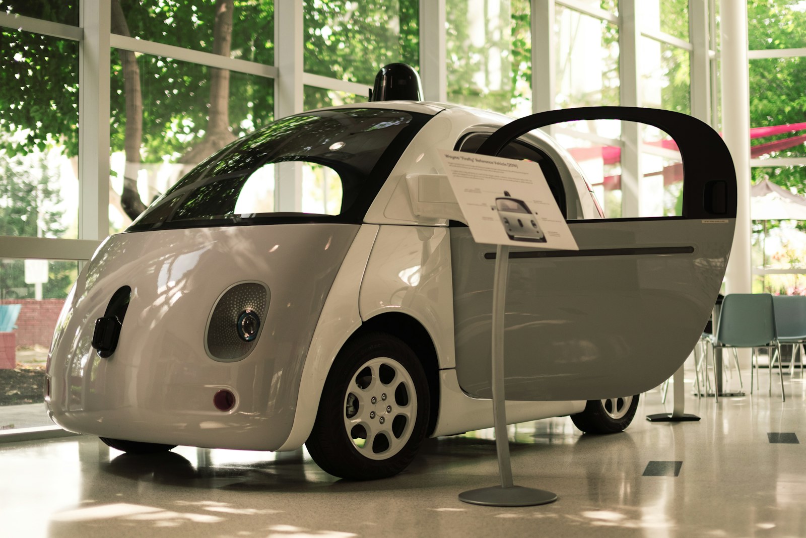 a small white car parked in a room