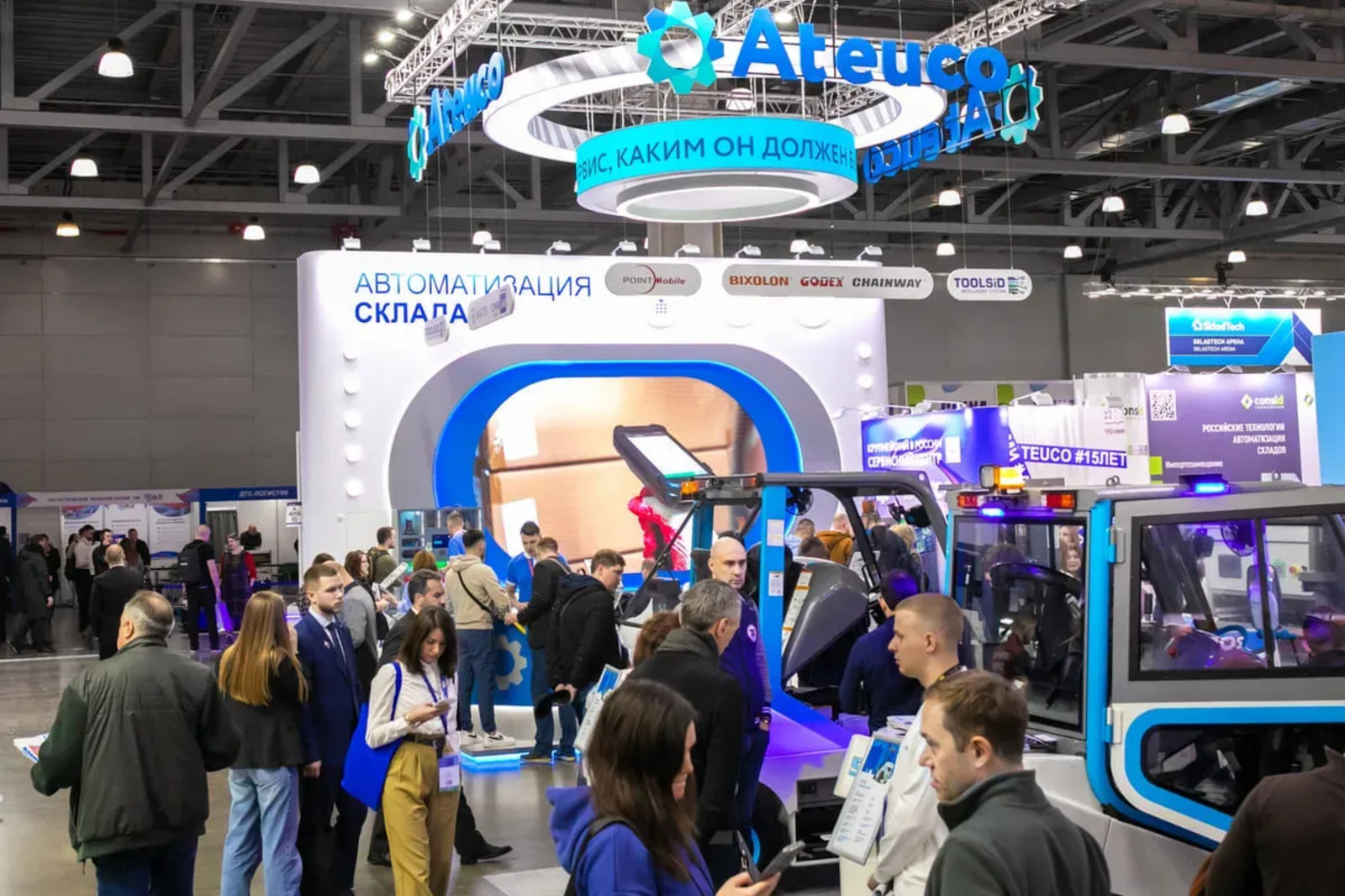 Crowd at an exhibition with booths and displays