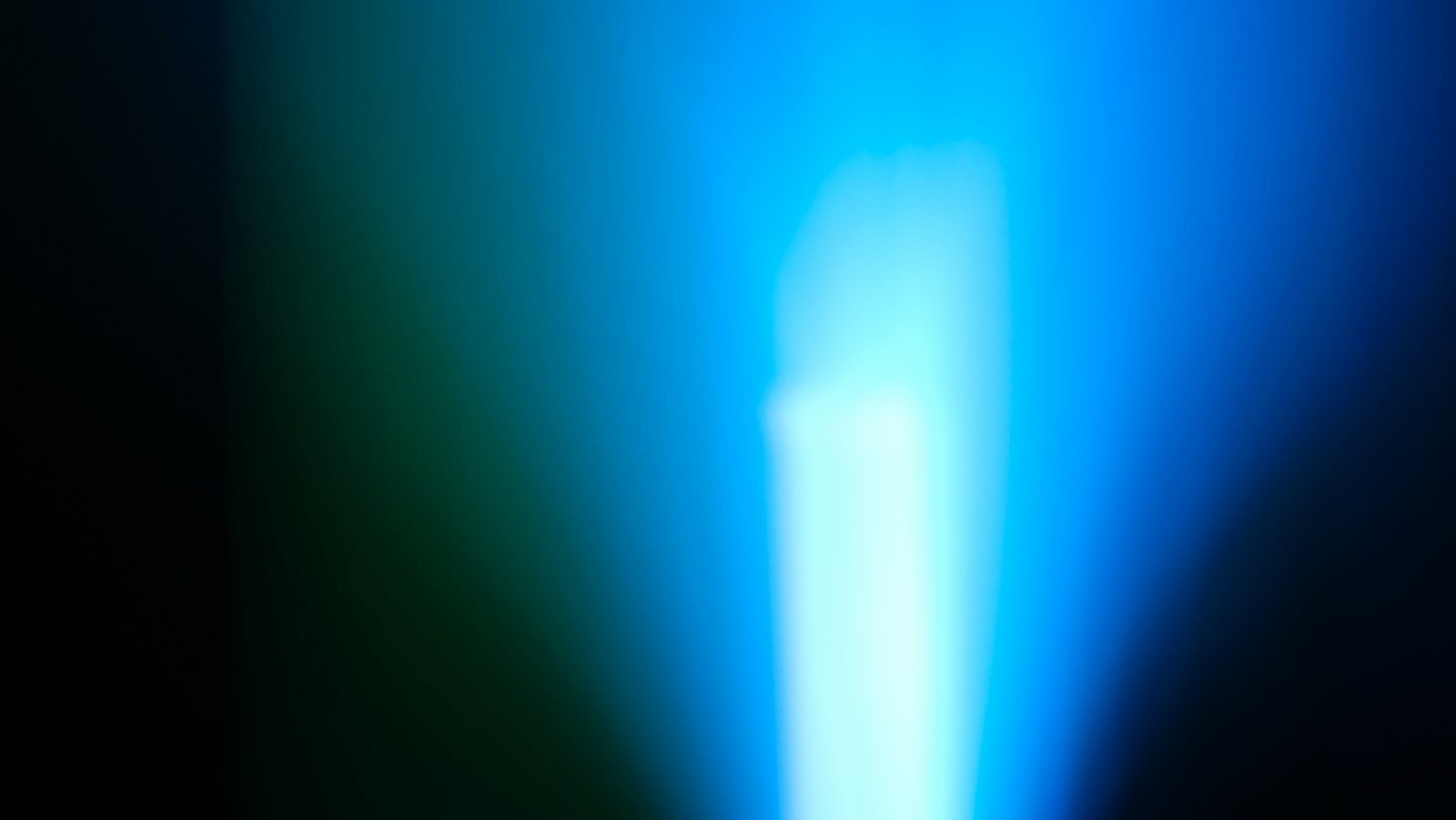 Blue and white light blends in a dark background